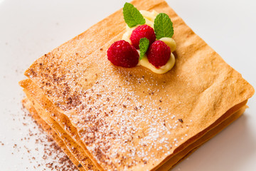 Pastry with mint and berries. Custard and chocolate crumbs. Expensive french dessert. Relax and enjoy your dessert.