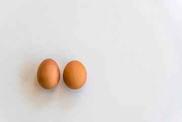 Top view of two eggs and isolated on white background with copy space