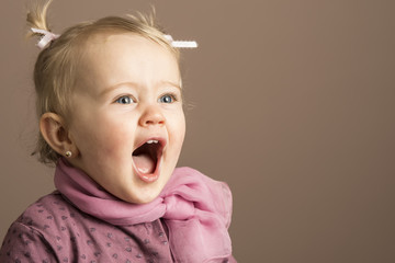 Beautiful happy little girl screaming