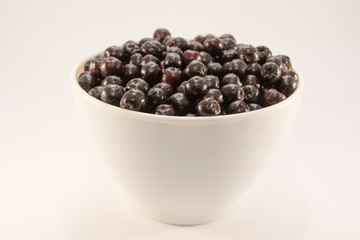 Wet aronia in white bowl