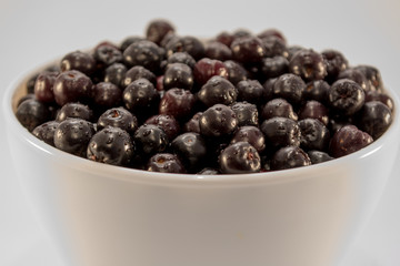 Wet aronia in white bowl