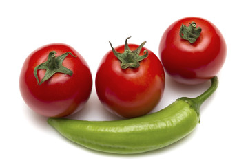 Green hot peppers and red tomatoes