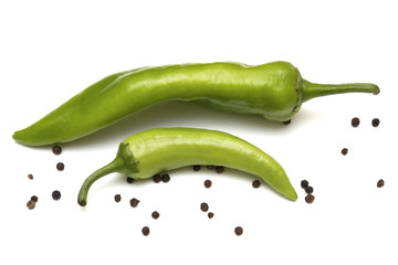 Two green hot pepper and black pepper