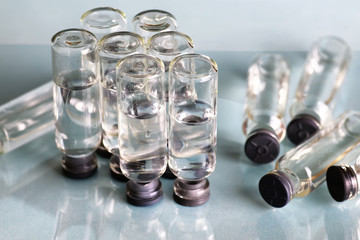 transparent vials of medicine