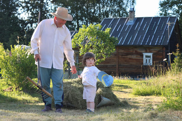 child and grandfather harvested hay