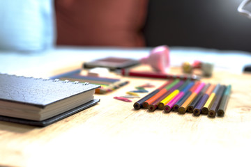 Colorfully Office and art stationery objects on wood table