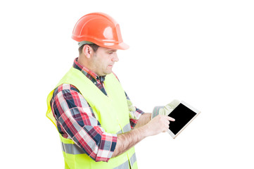 Male constructor pointing finger on tablet