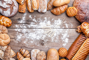 Delicious fresh bread on wooden background
