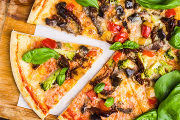 Fresh pizza served on wooden table