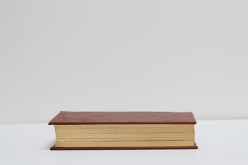 Hardback book on gray cloth. Back to school. Copy space