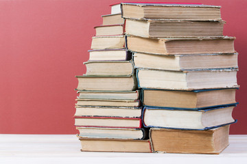Stack of hardback books on wooden table. Back to school. Copy space