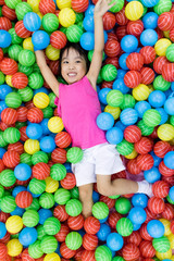 Fototapeta na wymiar Asian Little Chinese Girl Playing with Colorful Plastic Balls