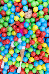 Fototapeta na wymiar Asian Little Chinese Girl Playing with Colorful Plastic Balls