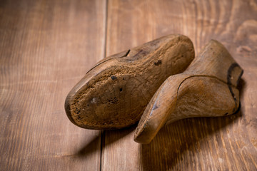 Shoe Lasts on the brown wooden background. Retro style