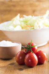 fresh lettuce salad with carrots cut into strips and whole tomatoes.