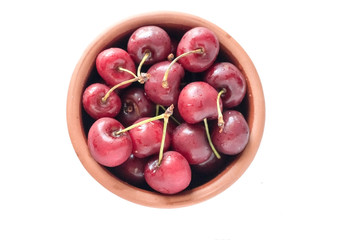 Isolated Cherries in a brown bowl