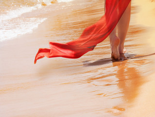 Frau mit rotem tuch am Strand