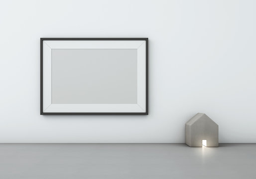 Blank black picture frame on white wall with wood house-shaped lamp - 3D rendering