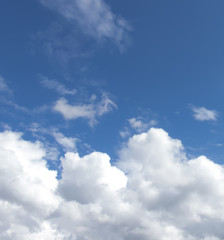 Fototapeta premium White clouds in a dark blue sky in Europe