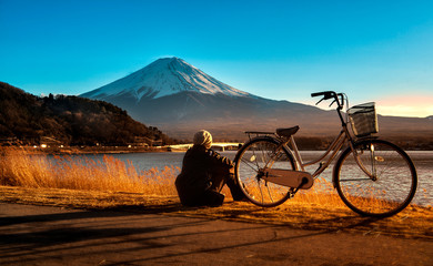 Mt Fuji sunset with one man and bicycle at Lake Kawaguchi in Fuji Kawaguchiko-machi, Japan.