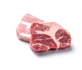 two pieces of marble raw beef on a white background