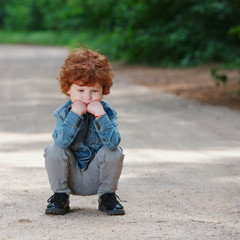 Fototapeta premium cute little emotional boy outdoors
