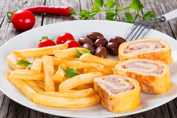 french fries on dish with baked cheese meat Roll-Ups