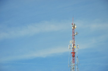 Obraz premium radio pole (telecommunication antenna) on blue sky and soft clouds background