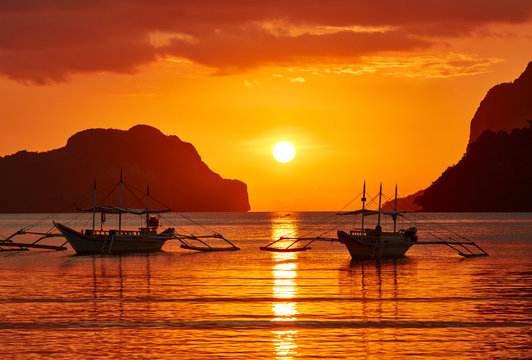 Traditional filippino boats at El Nido bay in sunset lights. Palawan