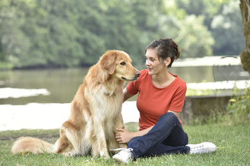 Woman relaxing with dog at the park