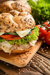 Fish burger with mackerel meat, cheese and fresh vegetable