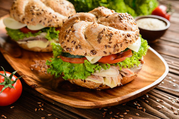 Fish burger with mackerel meat, cheese and fresh vegetable
