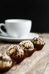 Delicious vegetarian truffle candies on wodden table.