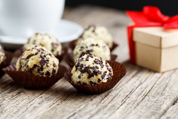 Delicious vegetarian truffle candies on wodden table.