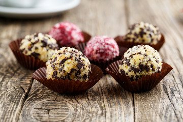 Delicious vegetarian truffle candies on wodden table.