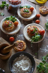 Rustic table with mini pizzas of bacon