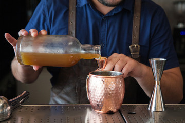 male bartender making cocktails