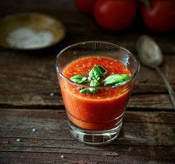 Fresh organic tomato juice on a wooden background