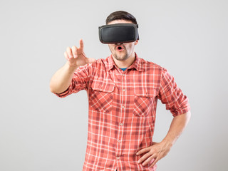 Man with virtual reality glasses showing gesture