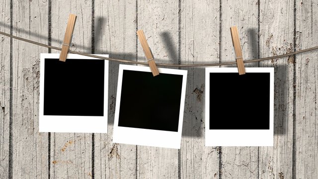three blank instant photos hanging on the clothesline  