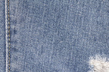 Naklejka premium Denim jeans texture or denim jeans background with seam and old torn of fashion jeans design with copy space for text or image.