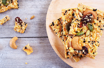 Top view of healthy cereal cracker on a wooden plate. Selective focus