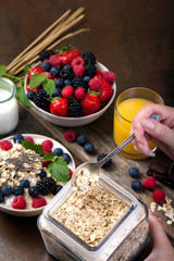 Spoon of oatmeal. Bowl with berries.