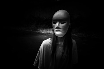 Dark doctrine,Mysterious woman wearing white mask,Scary background for book cover