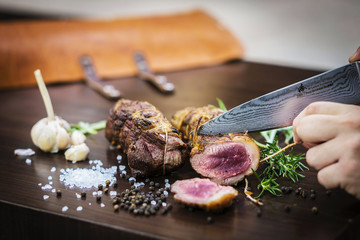 serving carving roast pork meat roll meal in rustic style