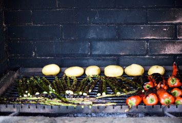 Photo of vegetables on grill, pepper, potatoes and asparagus, shallow focus.
