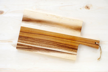 Empty wooden chopping board on table, background