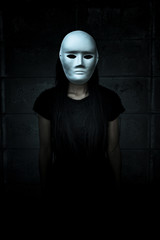  Mysterious woman in black dress wearing white mask,Scary background for halloween

