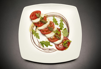 starter with mozzarella and tomato.