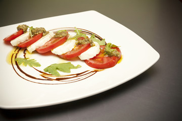 starter with mozzarella and tomato.
